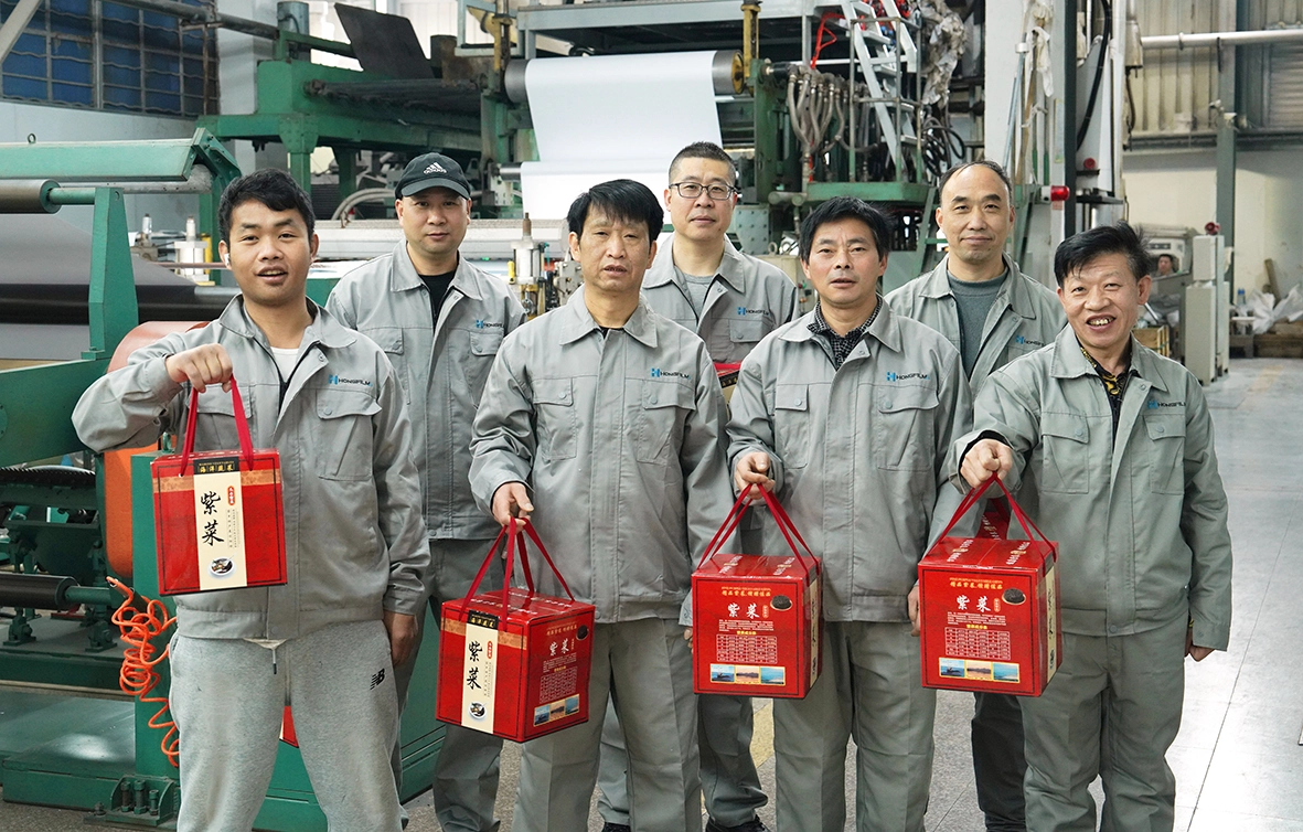 HongFilms team holding New Year gift packages